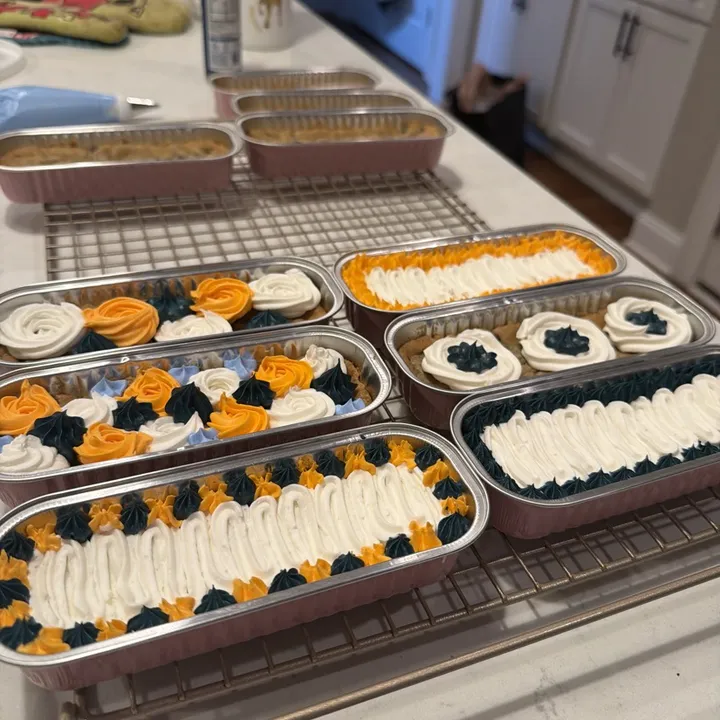 Decorated cookie cakes on a cooling rack: rosettes, star borders and ruffled centers